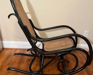 E56 - $30. Black painted caned rocking chair.