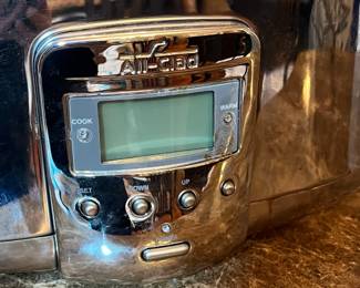 E117 - $100. All Clad Crock Pot. Lid has a dent on the rim - see photo.