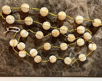 E125 - $60 EACH. 2 available. Vintage Crepe Paper Honey Comb Garland. Each is 104" long.