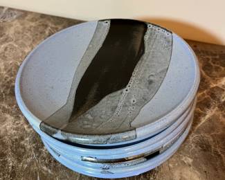 E99 - $100. Set of 8 "HOWE" Pottery Dinner Plates. Measures 8.5" across.