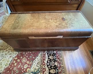 E51 - $50. Roos Cedar Chest. Measures 47" x 19" x 22.5" tall. Cedar on the inside is very nice - veneer needs some repair on the outside.