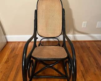 E56 - $30. Black painted caned rocking chair.