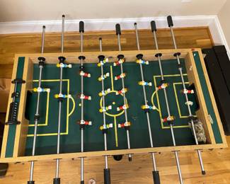 E109 - $50. Foosball Table. Was stored in the attic so the legs were already off. Legs, Hardware & Game Table all included.