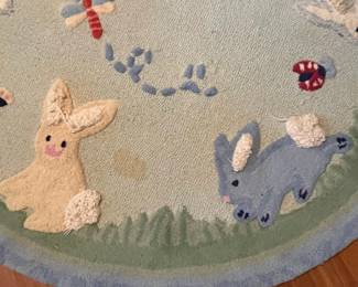 E52 - $50. Pottery Barn Kids Area Rug. Measures 60". Needs cleaned.
