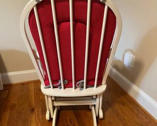 E57 - $40. White glider rocker. Has one small hole in cushion. Measures 21" wide x 40" tall.