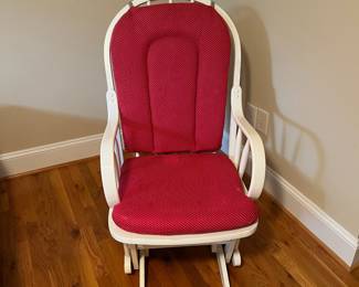 E57 - $40. White glider rocker. Has one small hole in cushion. Measures 21" wide x 40" tall.