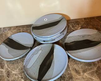 E99 - $100. Set of 8 "HOWE" Pottery Dinner Plates. Measures 8.5" across.
