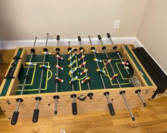 E109 - $50. Foosball Table. Was stored in the attic so the legs were already off. Legs, Hardware & Game Table all included. Table is 54" x 29" x 9.5" + legs.