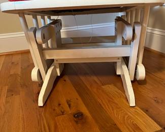 E57 - $40. White glider rocker. Has one small hole in cushion. Measures 21" wide x 40" tall.