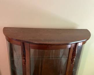 E44 - $100. Bow front curio with 3 glass shelves. Measures 34.5" wide x 14.25" deep x 57" tall.