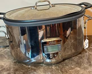 E117 - $100. All Clad Crock Pot. Lid has a dent on the rim - see photo.
