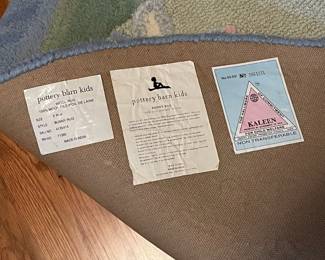 E52 - $50. Pottery Barn Kids Area Rug. Measures 60". Needs cleaned.