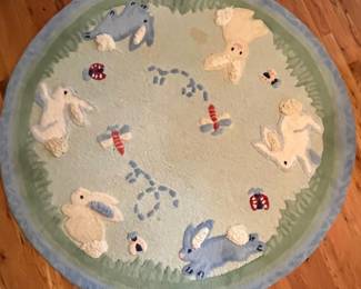 E52 - $50. Pottery Barn Kids Area Rug. Measures 60". Needs cleaned.