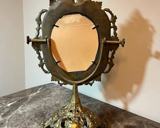 E73 - $40. Heavy Brass Table Mirror. Single sided mirror but does adjust up & down. Measures 11.5" x 17.5" tall.