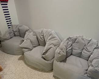 Three gray corduroy bean bag chairs