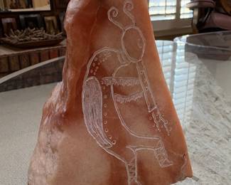 Hand-carved sculpture made from alabaster, a soft stone often used for art. The carving depicts a Native American figure, possibly a Kokopelli, playing a flute.