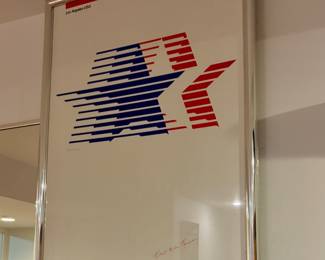 Signed poster for the 1984
Los Angeles Summer Olympics, featuring the official "Stars in Motion" logo.
• The logo was designed by graphic designer Robert Miles Runyan.