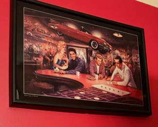 "Wet Knuckles Evening at Ricks". by artist George Bungarda. It depicts several iconic celebrities from the 1950s and 1960s gathered at a fictional cafe.
• The print features Marilyn Monroe, Elvis Presley, James Dean, and Humphrey Bogart.