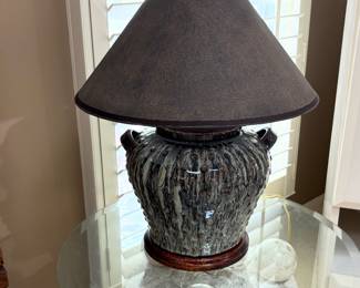 Thomas Blakemore figural table lamp with a textured ceramic base and original shade.