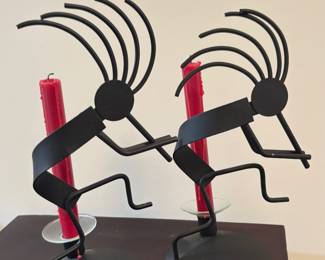Kokopelli-style metal candle holders.