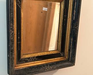 Lots of ornate wood frames and mirrors
