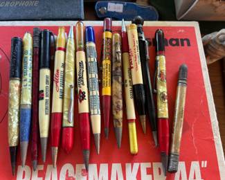 Lots of vintage advertisement pens and pencils