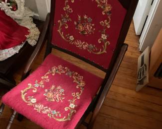Folding chairs with red floral embroidered upholstery