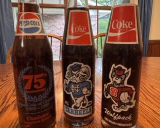 Commemorative Pepsi bottle from 1980, Commemorative Coca Cola bottles from 1982 UNC National Championship and 1983 NC State National Championship