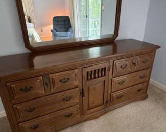 Triple dresser with attached mirror