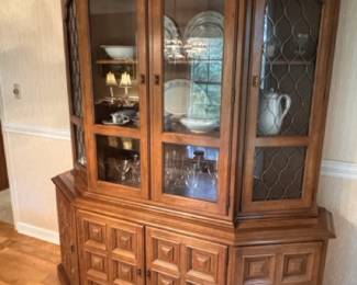 Heavy china cabinet with multiple display sections and storage underneath.
