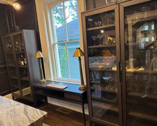 glass front cabinets, west elm console table and vintage brass buffet lamps.