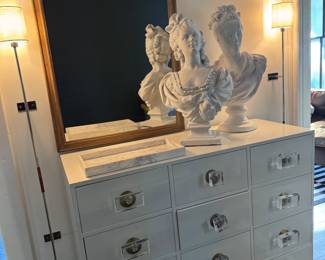 plug in CB2 wall mounted lamps, life sized busts, mirror and anthropologie chest of drawers.