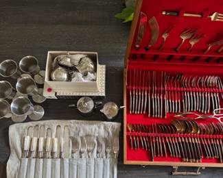 multiple sets of flatware from 4 to 34 place settings.