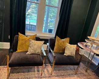 CB2 polished brass arm chairs.