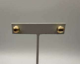 Pair of gold-colored spherical stud earrings with textured surface. Earrings have standard post backings and are displayed on a white stand and a digital scale showing 0.031 grams. 8.5 mm.
