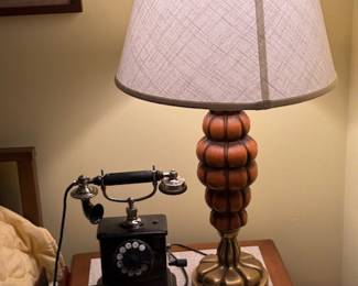 Vintage Rotary Telephone and Decor
Classic black rotary telephone displayed with mid-century lamp and royal biography books. A nostalgic vignette perfect for collectors of vintage decor or British royal history enthusiasts.