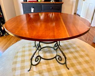 $450 - Wood Top round dining table with heavy iron base - 48x29.5