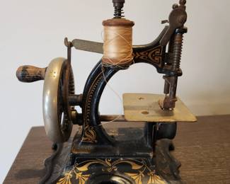 Antique FW Muller Model 20 cast iron miniature sewing machine. Hand crank (still works!).