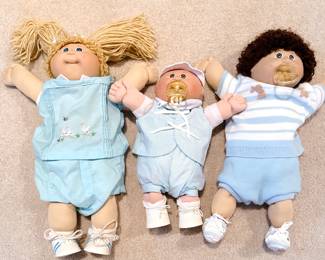 cabbage patch newborn premie, cabbage patch girl with blond pigtails, and cabbage patch boy with brown hair