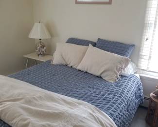 Queen bed; end table; table lamp; artwork