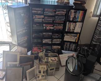 Lots of radios stereo equipment picture frames VCR tapes cassette tapes DVDs CDs