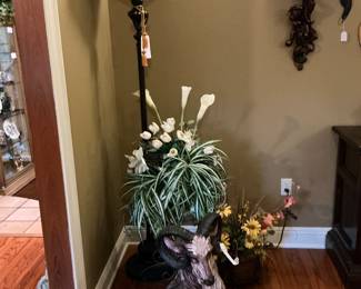 in front is a very heavy more than likely plaster of Paris RAM, behind your find Calla lilies in a pot, look at the gorgeous Tiffany style floor lamp, beautiful colors
