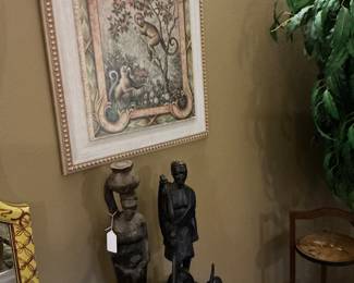 The African couple was hand carved in Africa. They are marked. Above that you will find a print of swinging monkeys