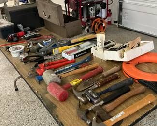Variety of hammers pipe wrenches some still new in the box
