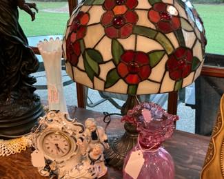 There was a Dutch man and woman, colonial clock, a Tiffany style lamp, Fenton vase.