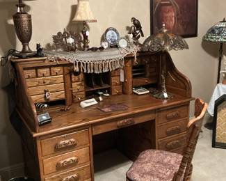 This is a roll top secretary, desk favors Tiger Oak nice press back office chair the lamp you see in the corner is a slag Miller lamp