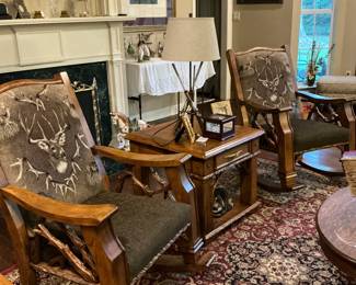 Set of matching Marshfield deer rocking chairs and table in the middle with a hunting lamp