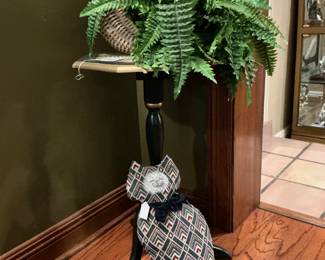 Cute little quilted kitty with a basket of Fern on a table