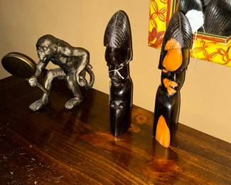 Here is a monkey looking at his reflection also a pair of hand carved African statues