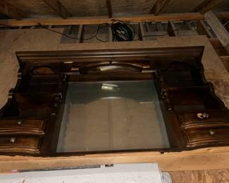This is located in the attic. It’s the top of a bed or maybe even a buffet.